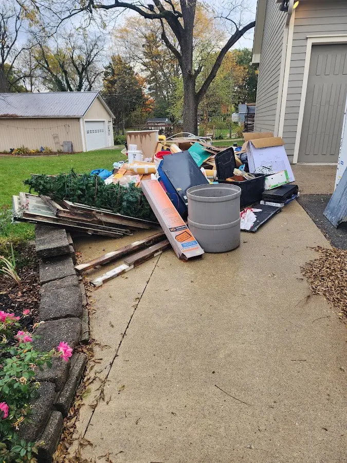 Dumpster being loaded with debris for 3 Yard Dumpster Rental in Webster